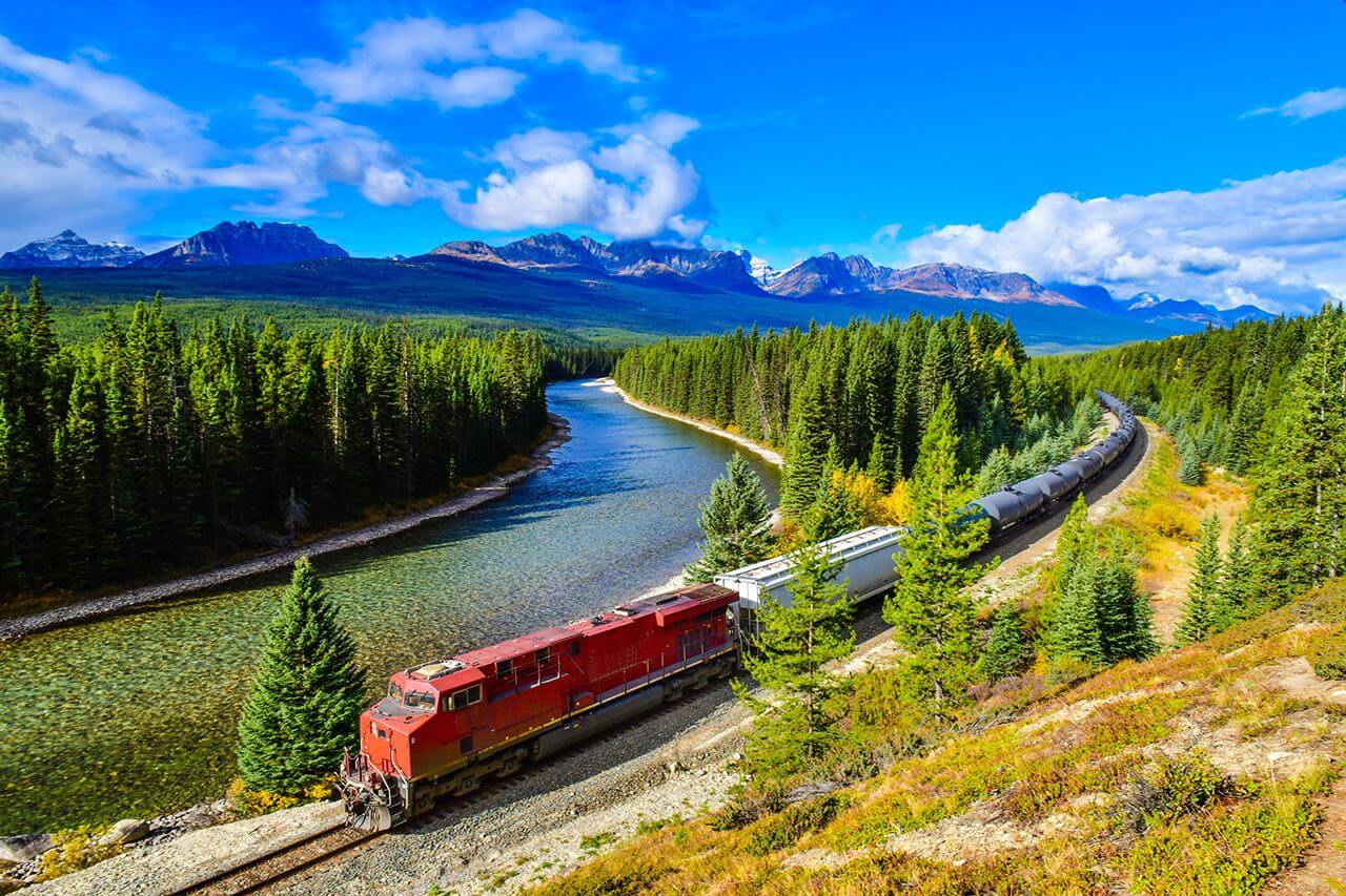Train on tracks moving through country